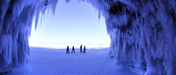 People walk past a cave at Apostle Islands National Lakeshore in northern Wisconsin. The caves are usually accessible only by water, but Lake Superior’s rock-solid ice cover is letting people walk to them for the first time since 2009. Photograph: Brian Peterson/AP
